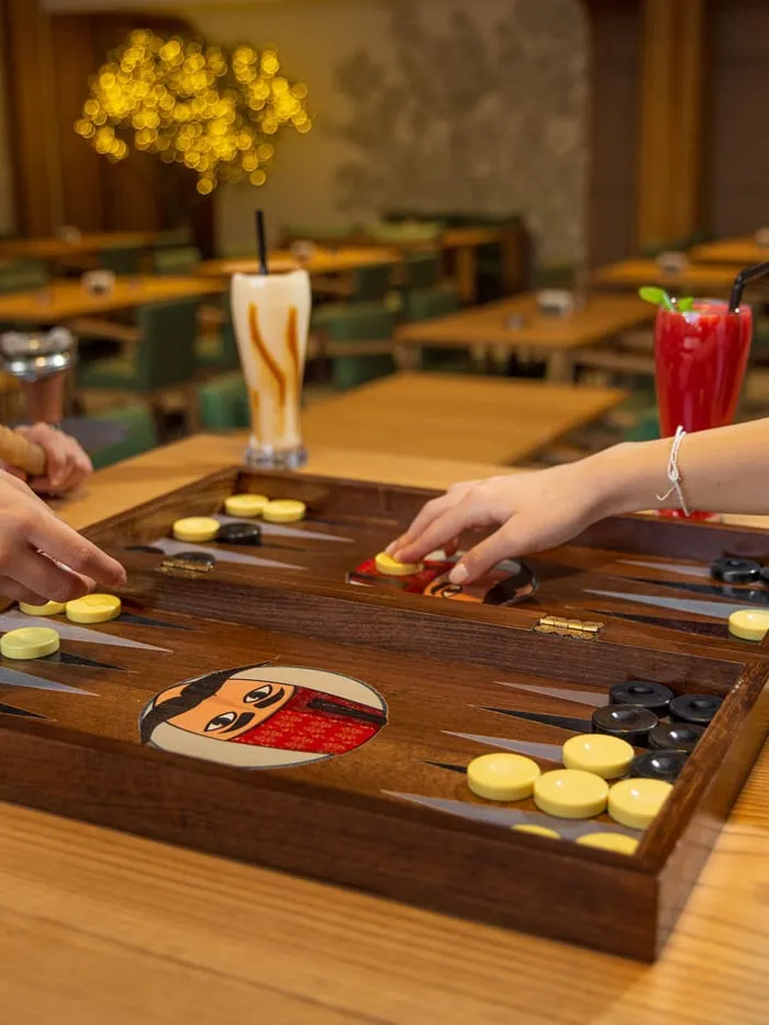 A game of backgammon on a board carrying the Abu El Zulof face